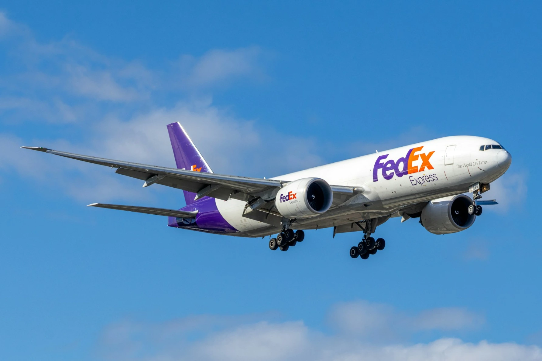 Fedex cargo plane flying in a blue sky
